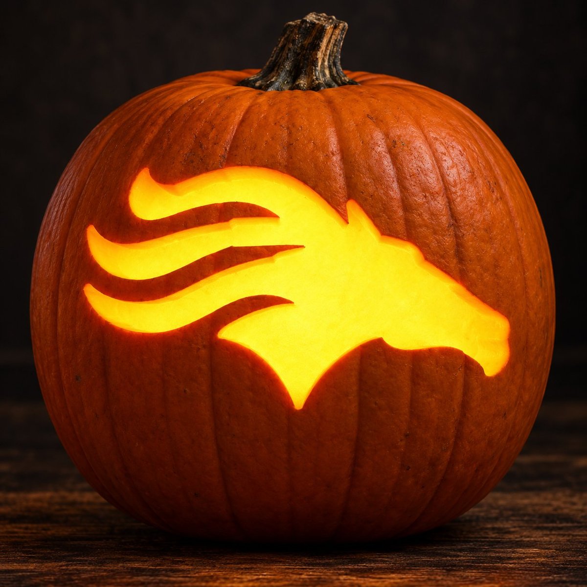 Jack-o-lantern pumpkin with a glowing horse head carved design on dark background